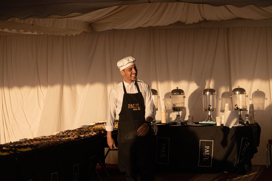 Smiling professional catering staff serving guests